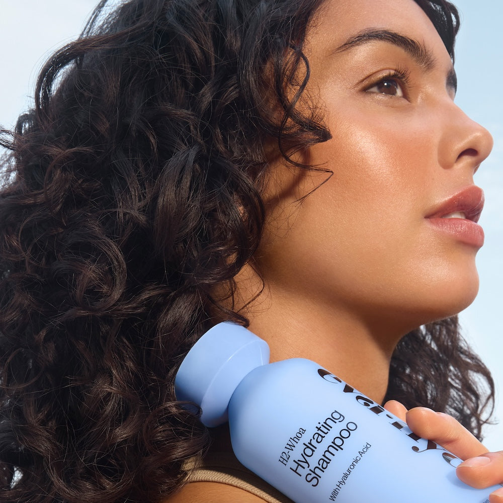 Model holding H2-Whoa Hydrating Shampoo